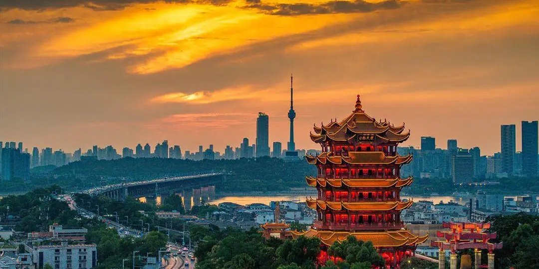 Classical painting of Yellow Crane Tower during sunset with boats sailing on the Yangtze River